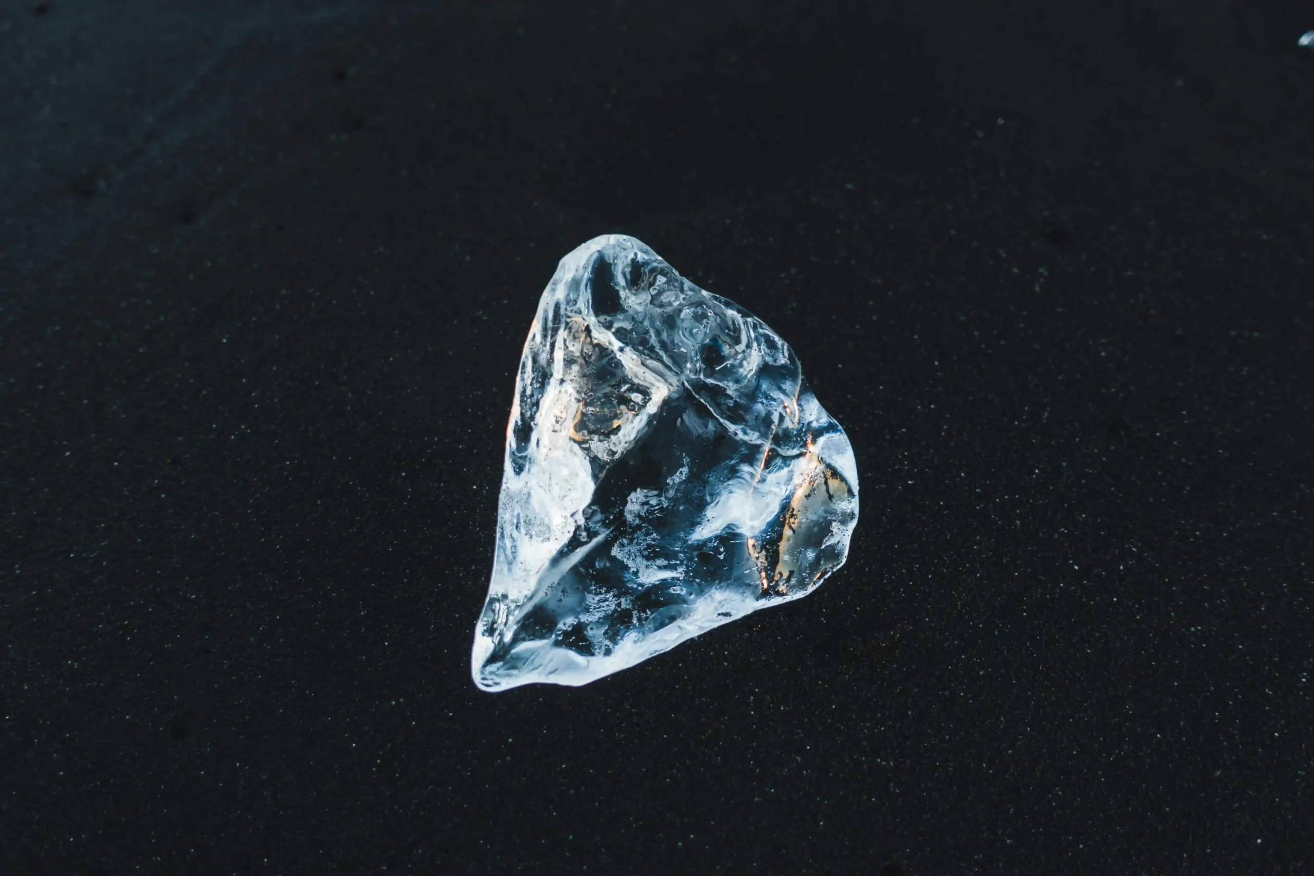 Hands inspecting a loose diamond with a loupe for GIA and EGL grading assessment